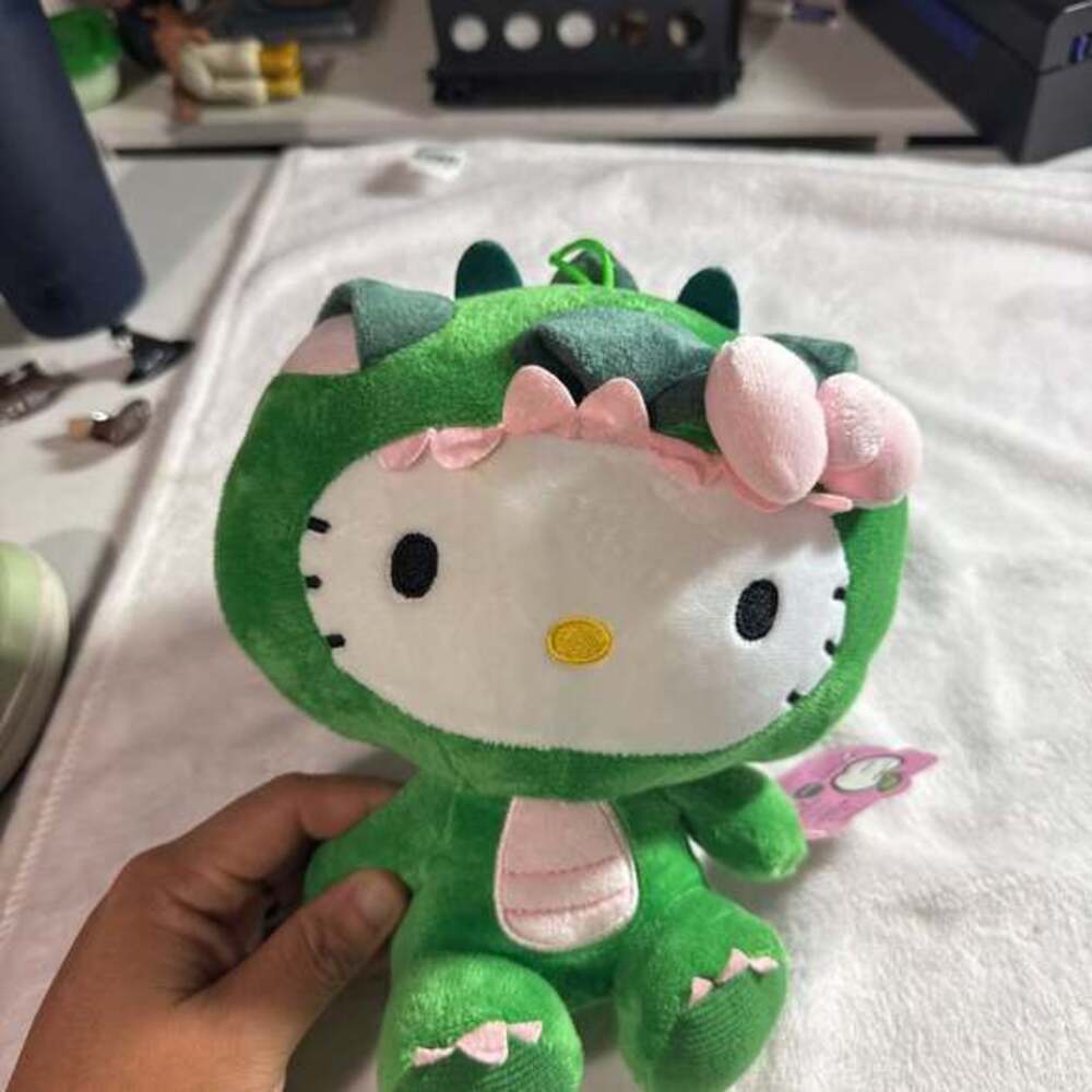 Hello Kitty Green Dinosaur Plush with Pink Bow